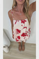 Video of a woman wearing the Soleia Playsuit in Arli Print, a spaghetti strap cami overlay playsuit in a cream and red bold floral print