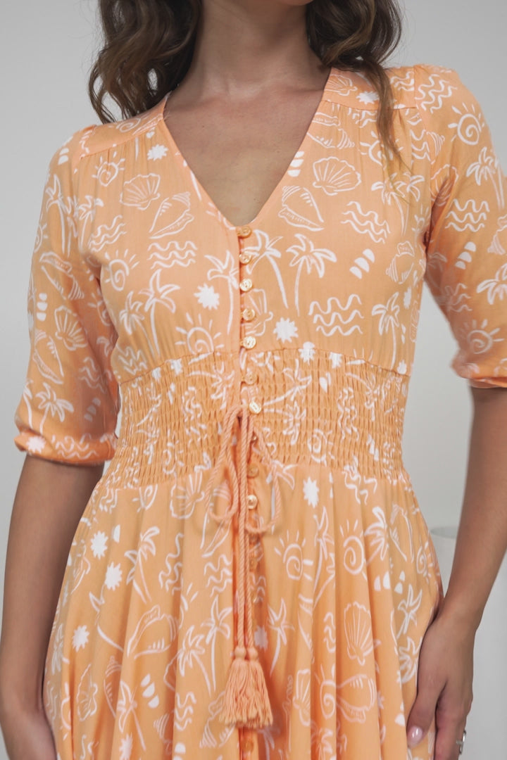 JAASE - Indiana Maxi Dress: Lace Back Shirred Waist A Line Dress with Handkerchief Hemline in Peach Island Print