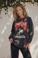 Woman wears a print tee with Long Live Cowgirls